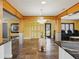 Spacious living area with yellow walls, white trim, and stone flooring with views to other rooms at 402 S Barbara Ln, Tampa, FL 33609