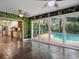View from enclosed patio to modern kitchen and screened-in pool at 402 S Barbara Ln, Tampa, FL 33609
