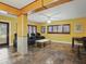 Spacious living room with a ceiling fan, theater-style chairs, stone floors and natural light at 402 S Barbara Ln, Tampa, FL 33609