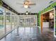 Enclosed patio with slate floor, colorful decor, and view of the screened-in pool at 402 S Barbara Ln, Tampa, FL 33609