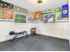 This workout room features black rubber floors and colorful art on the walls at 402 S Barbara Ln, Tampa, FL 33609