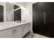 Modern bathroom features a double sink vanity, large mirror, and dark wood storage at 4118 Gauge Line Loop, Tampa, FL 33624