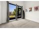 Bright bedroom features a large window, grey carpet, and modern decor at 4118 Gauge Line Loop, Tampa, FL 33624