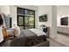 Bedroom with a large window, mirrored dresser, and stylish decor at 4118 Gauge Line Loop, Tampa, FL 33624