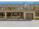 Contemporary townhome exterior featuring a private carport, garage, gray brick drive and modern architectural details at 4118 Gauge Line Loop, Tampa, FL 33624