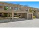 Exterior view of modern townhomes with carport and manicured landscape and brick driveway at 4118 Gauge Line Loop, Tampa, FL 33624