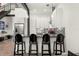 Contemporary kitchen features stainless steel appliances, sleek white cabinets, breakfast bar and modern pendant lighting at 4118 Gauge Line Loop, Tampa, FL 33624
