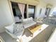 Private balcony seating area with wicker furniture and views of the water at 4141 Bayshore Blvd # 1103, Tampa, FL 33611