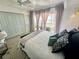 Comfortable bedroom with neutral walls, light colored floors, and a view of the water from a private balcony at 4141 Bayshore Blvd # 1103, Tampa, FL 33611