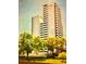 A beautiful exterior view of the condo building surrounded by lush green trees at 4141 Bayshore Blvd # 1103, Tampa, FL 33611
