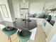 The kitchen features new appliances, white cabinets, and a black countertop island with seating at 4141 Bayshore Blvd # 1103, Tampa, FL 33611