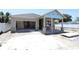 New construction features an attached garage, covered porch with columns, and a neutral color palette at 4244 11Th N Ave, St Petersburg, FL 33713