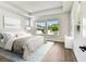 Serene main bedroom with a plush bed, tray ceilings, and bright windows at 4244 11Th N Ave, St Petersburg, FL 33713