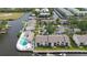 Aerial view of waterfront condos, with pool and boat docks, located on a serene canal at 428 Moorings Cove Dr # 7F, Tarpon Springs, FL 34689