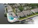 Aerial view highlights waterfront living with condos, boat docks, and a community pool at 428 Moorings Cove Dr # 7F, Tarpon Springs, FL 34689