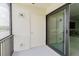 Cozy balcony featuring a door and sliding glass doors providing seamless indoor-outdoor living at 428 Moorings Cove Dr # 7F, Tarpon Springs, FL 34689