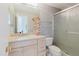Bathroom with granite countertop, white cabinets, and shower with glass door at 428 Moorings Cove Dr # 7F, Tarpon Springs, FL 34689