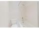 Clean white bathroom featuring a standard toilet and bathtub with shower at 428 Moorings Cove Dr # 7F, Tarpon Springs, FL 34689
