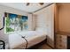Bright bedroom featuring a Murphy bed, neutral walls, and a window with views at 428 Moorings Cove Dr # 7F, Tarpon Springs, FL 34689