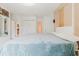 Bedroom featuring a large bed, closet space and connection to ensuite bathroom at 428 Moorings Cove Dr # 7F, Tarpon Springs, FL 34689
