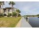 Exterior showcases a waterside community with palm trees, lush lawns, and dock access at 428 Moorings Cove Dr # 7F, Tarpon Springs, FL 34689