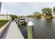 Picturesque dock view showcasing boat mooring, tranquil canal waters, and lush landscaping nearby at 428 Moorings Cove Dr # 7F, Tarpon Springs, FL 34689
