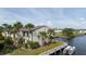 Exterior of waterfront condo with boat dock access and well-maintained landscaping at 428 Moorings Cove Dr # 7F, Tarpon Springs, FL 34689