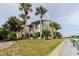Exterior showcases a waterside community with palm trees, lush lawns, and dock access at 428 Moorings Cove Dr # 7F, Tarpon Springs, FL 34689