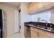 Kitchen featuring light wood cabinets, stainless steel appliances and in-unit laundry closet at 428 Moorings Cove Dr # 7F, Tarpon Springs, FL 34689