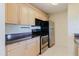 Functional kitchen featuring light wood cabinets, stainless appliances and stylish countertops at 428 Moorings Cove Dr # 7F, Tarpon Springs, FL 34689