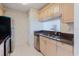 Charming kitchen features light wood cabinetry, stainless appliances, and double-bowl sink at 428 Moorings Cove Dr # 7F, Tarpon Springs, FL 34689
