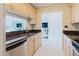 Open concept kitchen with light wood cabinets, solid countertops, and view of the living area at 428 Moorings Cove Dr # 7F, Tarpon Springs, FL 34689