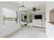 Bright living room offering a waterfront view, ceiling fan and balcony access via sliding glass door at 428 Moorings Cove Dr # 7F, Tarpon Springs, FL 34689