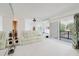 Bright living room with a ceiling fan, sliding glass doors to a balcony, and waterfront views at 428 Moorings Cove Dr # 7F, Tarpon Springs, FL 34689