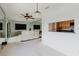 Bright, open-concept living room with a pass-through to the kitchen and a large wall mirror at 428 Moorings Cove Dr # 7F, Tarpon Springs, FL 34689