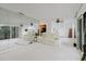 Open-concept living room boasts a large wall mirror, and an adjacent balcony with waterfront views at 428 Moorings Cove Dr # 7F, Tarpon Springs, FL 34689