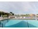 Community swimming pool featuring inviting, clear water, comfortable lounge chairs, and a tranquil atmosphere for residents at 428 Moorings Cove Dr # 7F, Tarpon Springs, FL 34689