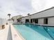 Inviting community pool featuring crystal-clear water, poolside seating, and a well-maintained surrounding area at 428 Moorings Cove Dr # 7F, Tarpon Springs, FL 34689