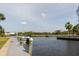 Picturesque dock view showcasing boat mooring, tranquil canal waters, and lush landscaping nearby at 428 Moorings Cove Dr # 7F, Tarpon Springs, FL 34689