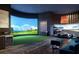 An entertainment room with simulated golf and racing games, a putting green, and stylish seating at 520 N Tampa St # 1508, Tampa, FL 33602