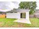 Backyard view featuring a concrete patio, a back entrance, and a well-maintained lawn at 538 Summer Sails Dr, Valrico, FL 33594