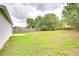Spacious backyard featuring a lush green lawn and a wooden fence at 538 Summer Sails Dr, Valrico, FL 33594