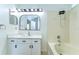 Bright bathroom featuring a sleek vanity, shower-tub combo, and a modern mirror at 538 Summer Sails Dr, Valrico, FL 33594