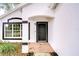 Close up of front door with brick landing and black trim at 538 Summer Sails Dr, Valrico, FL 33594