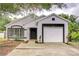 Charming single-story home with a white exterior, black trim, and attached garage for modern curb appeal at 538 Summer Sails Dr, Valrico, FL 33594