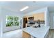 Modern kitchen with stainless steel appliances, stone countertops, and ample natural light from the large window at 538 Summer Sails Dr, Valrico, FL 33594