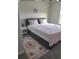 Comfortable bedroom with bed, side table, carpet, and soft colors at 5511 Rainwood Meadows Dr, Apollo Beach, FL 33572