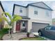 Charming two-story home with landscaped yard, featuring a cozy front porch and well-maintained lawn at 5511 Rainwood Meadows Dr, Apollo Beach, FL 33572