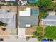 An aerial shot showing a home with a screened-in pool, fenced backyard, and mature trees at 5810 8Th Ave, New Port Richey, FL 34652