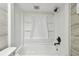 Updated bathroom featuring a shower-tub combination with gray accent tiles and modern fixtures at 5810 8Th Ave, New Port Richey, FL 34652
